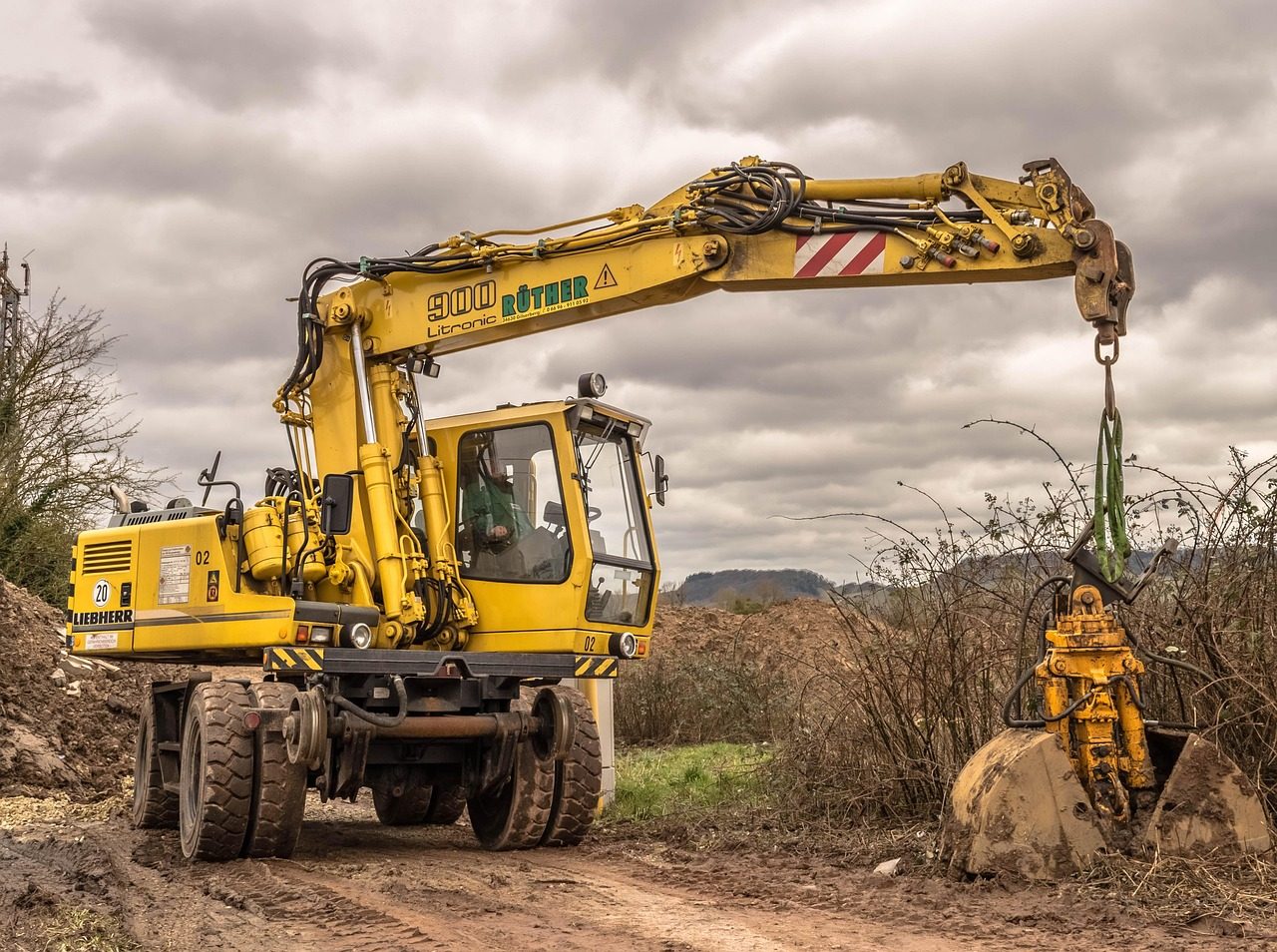 Excavator clearing and grading a lot near Hartford, CT
